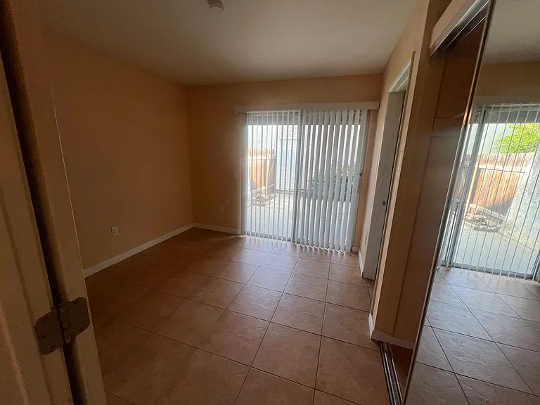 Downstairs Bedroom with Private Bathroom and Access to Backyard / Garage