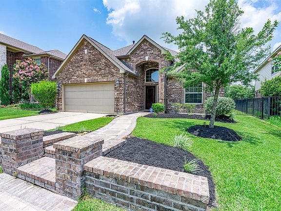 A curved sidewalk outlined in brick leads you to the front porch and adds wonderful curb appeal!