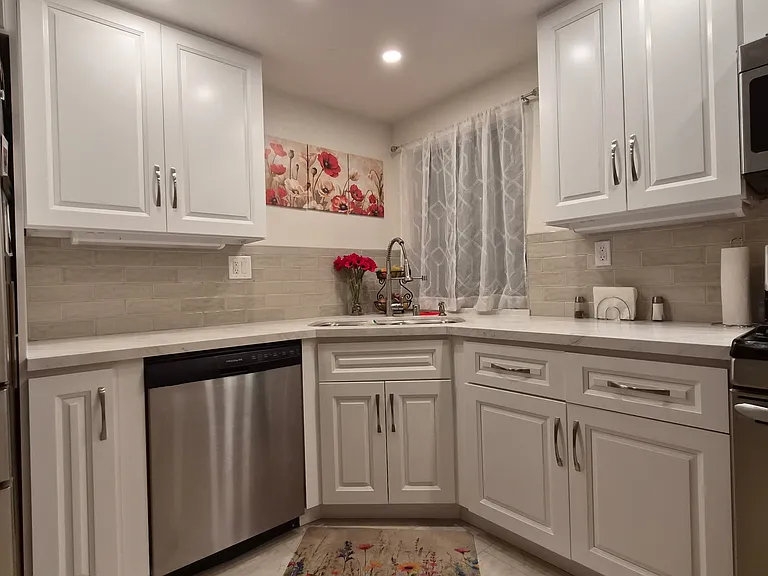 New modern kitchen cabinets and quartz counter tops with tile back splash and tile floors