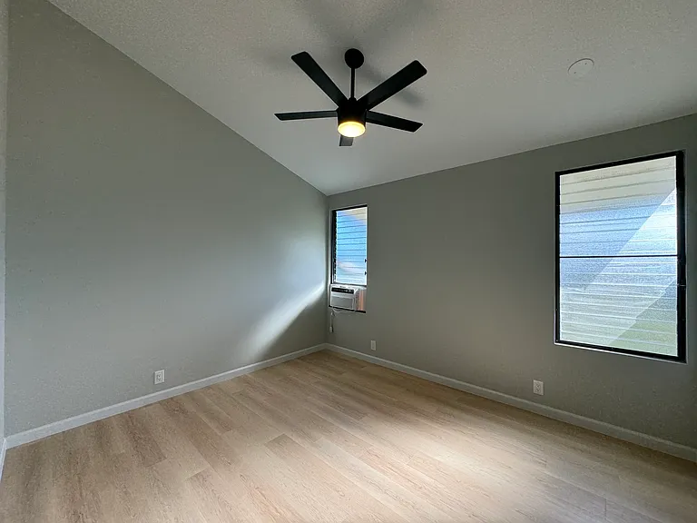 Bedroom #2 upstairs. Window AC, high ceilings and fan/light.