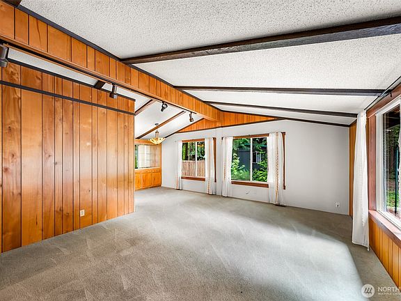 Open beam vaulted ceilings create a bright and welcoming living space.>