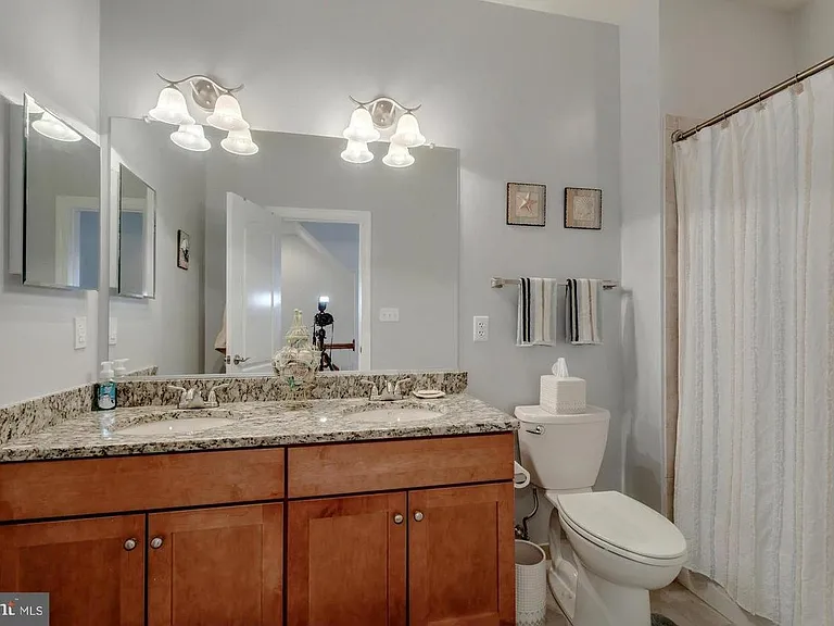 Master bathroom with granite counter top and vanity cabinet