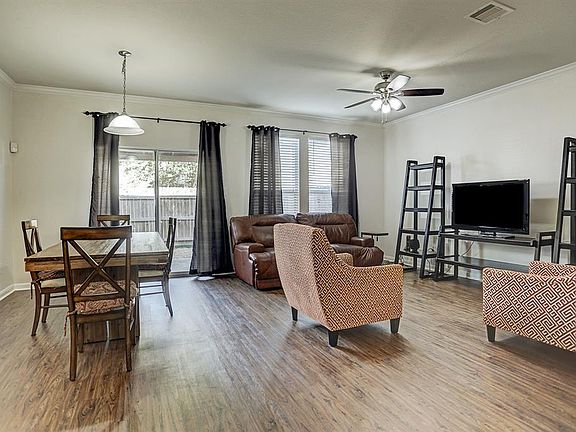 Walk into the spacious living area that perfectly fits a living room set and dining table.