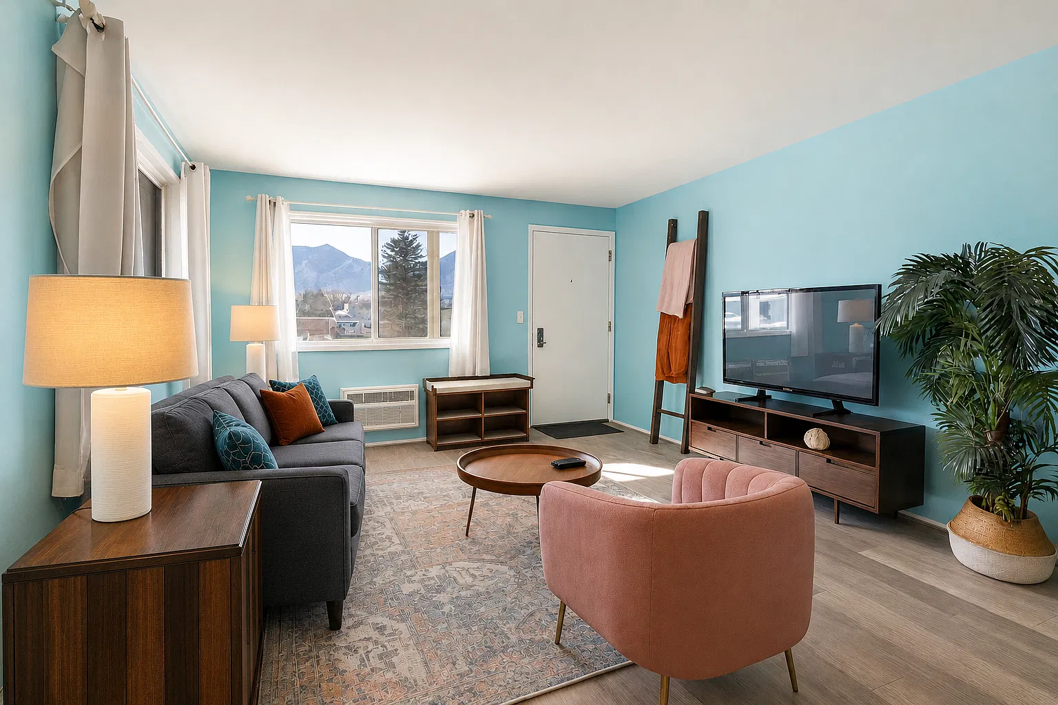 Framed by windows and full of light, this living room offers mountain scenery, soft seating, and all the cozy touches to make you feel right at home.