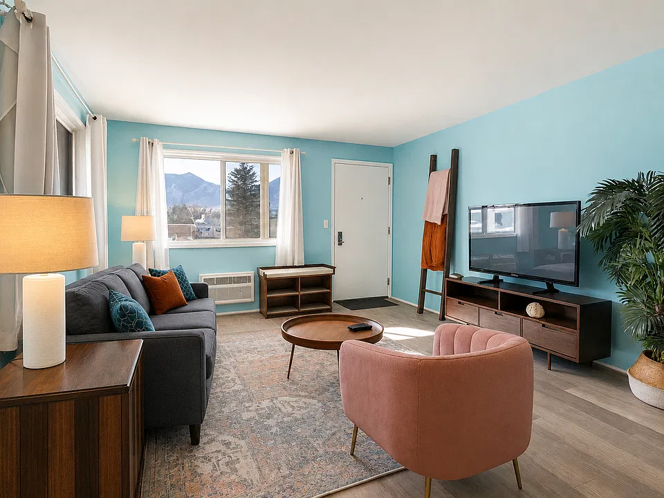 Framed by windows and full of light, this living room offers mountain scenery, soft seating, and all the cozy touches to make you feel right at home.