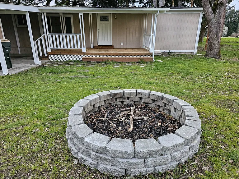 Firepit and view of the back of the home.
