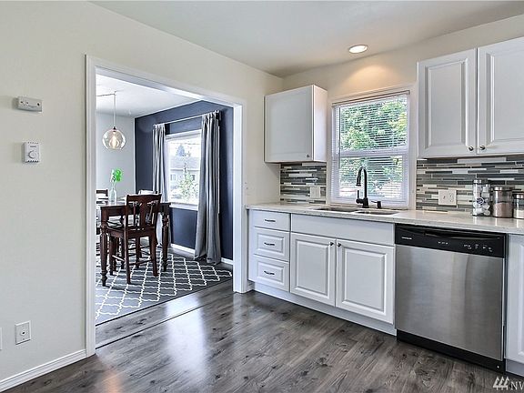 Large kitchen with great back splash and included stainless steel appliances. 