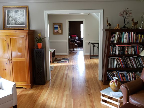 View from cener of living room through entry into den