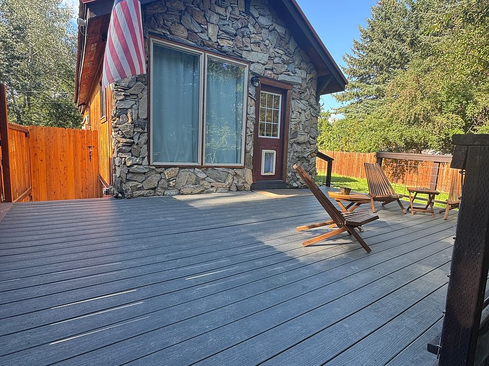 Front of home with nice deck and chairs