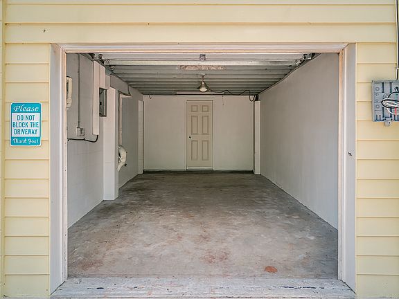 One car garage emptied view, smaller car would be best. The door in back leads to the utility room, currently a work bench in back left side that can be left if wanted