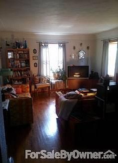 Family Room
						:
						View of the family room from the kitchen entry. Wood floors and coved ceilings.
