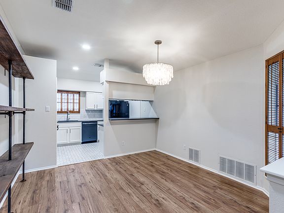 Dining room with built in shelving and West Elm light fixture.