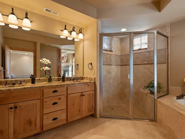 Master shower area, travertine tile