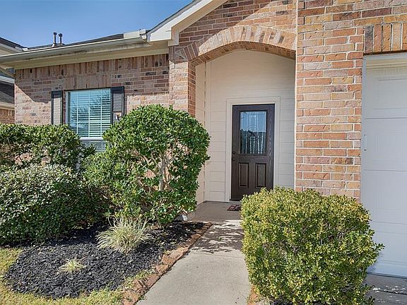 The wonderful garden with stone accents along the sidewalk that leads to the front door.