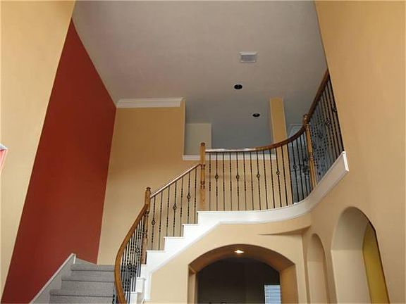 Dramatic stairway is the view upon entering the home.