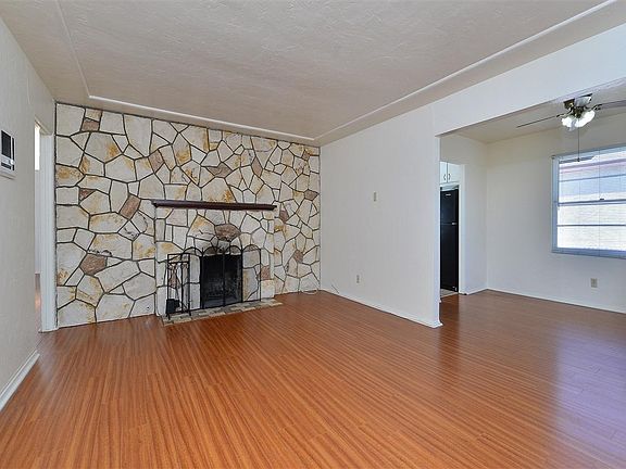 laminate floors, fire place in a large living room
