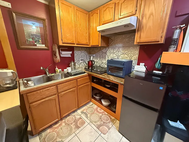 Kitchen is small but super functional with wonder oven pro (it's amazing -look it up). Kitchen island on wheels, 4 burner electric. Lots of kitchen gear!