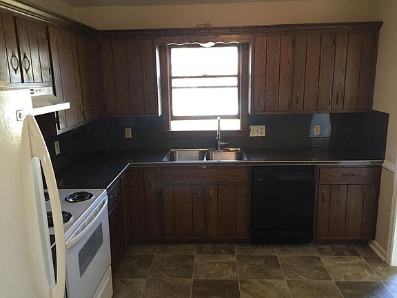 KITCHEN WITH WINDOW OVER SINK LOOKING OUT TO THE BACK YARD.