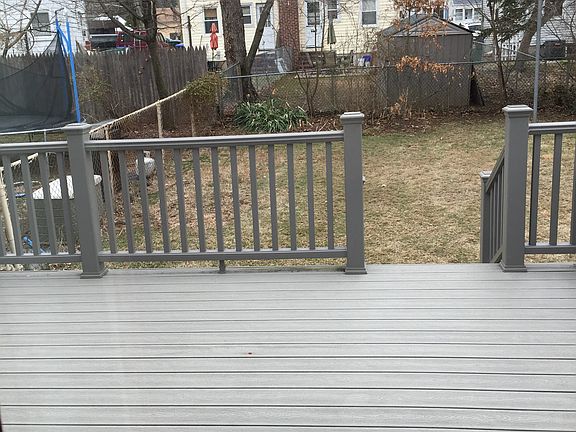 deck and fenced backyard
