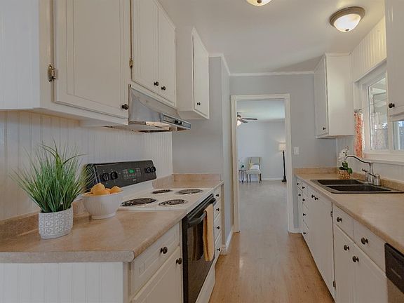 The painted cabinets and lovely floors make this kitchen a place you'll love spending time in.