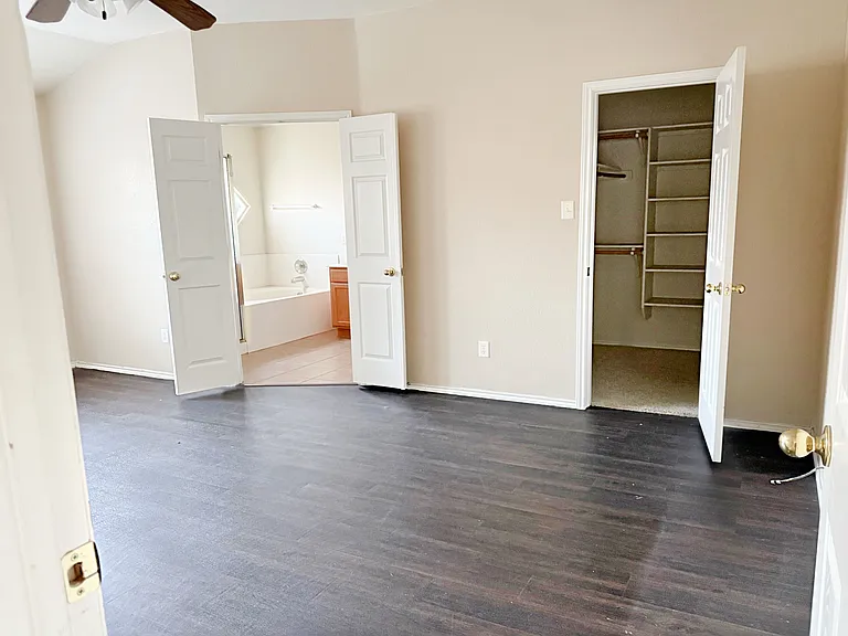 Master bedroom with large walk-in closet, ceiling fan/light