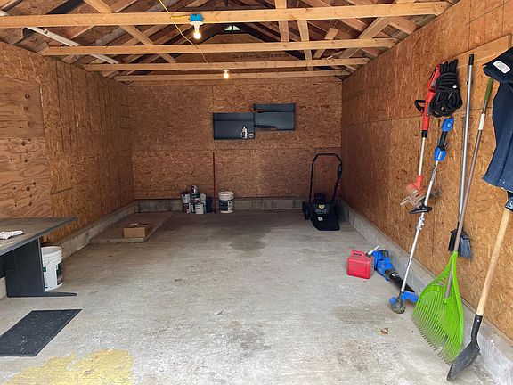 Garage-sized shed. Table and shelving will remain. All other items will be removed.