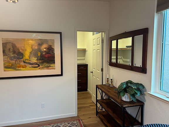 Bedroom with view into walk-in closet.