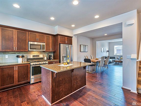 Great room concept, hardwood floor throughout, windows on both sides of the room and balcony off the living room.