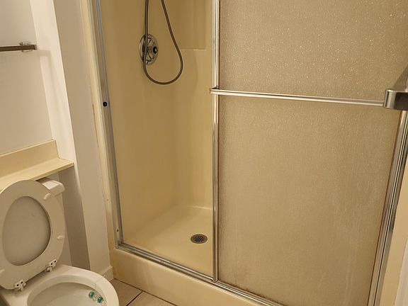 Master bathroom is equipped with a shower for ease of access and boasts grab bars to prevent falls.