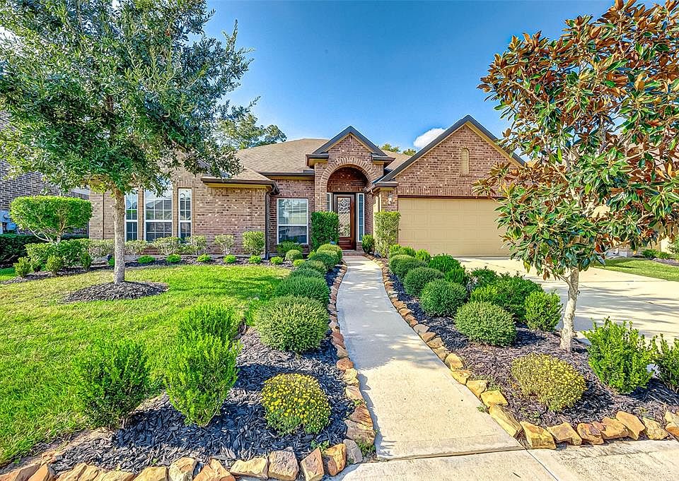 Stunning 1-story Perry home with mature landscaping and lush green shrubs and trees. Notice the handsome covered arched porchway, 2-car garage and double wide driveway, providing plenty of space for family and friends to park.