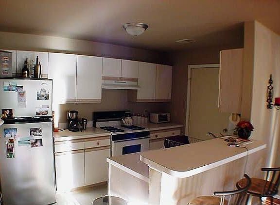 Galley kitchen with stainless appliances