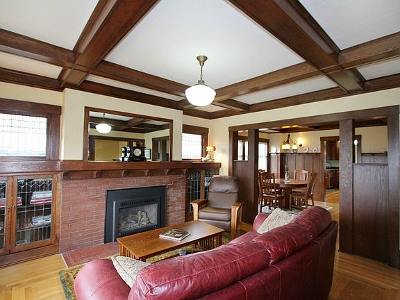 Formal Living Room. With box-beam ceilings, original leaded glass & gas fireplace. Plus full insulation in walls, ceilings & roof!