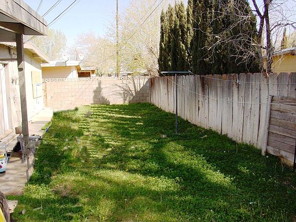 Rear fenced grassy yard
