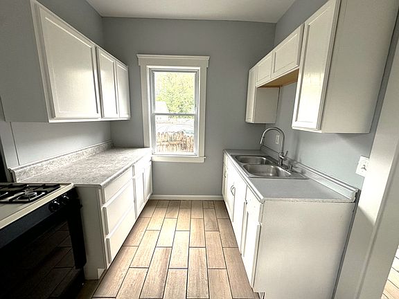 Updated kitchen with fridge, stove, and plenty of cabinet storage