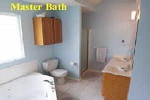 master bath with corner whirlpool tub/double vanities