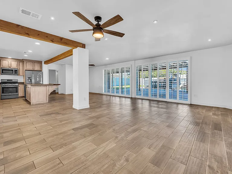Open living room with a view of pool