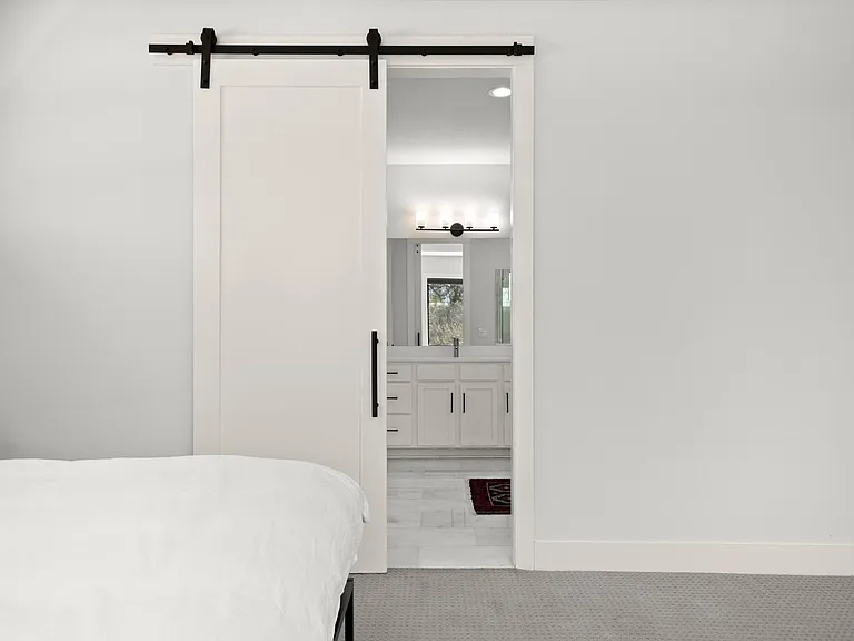 barn door to bath & walk in closets