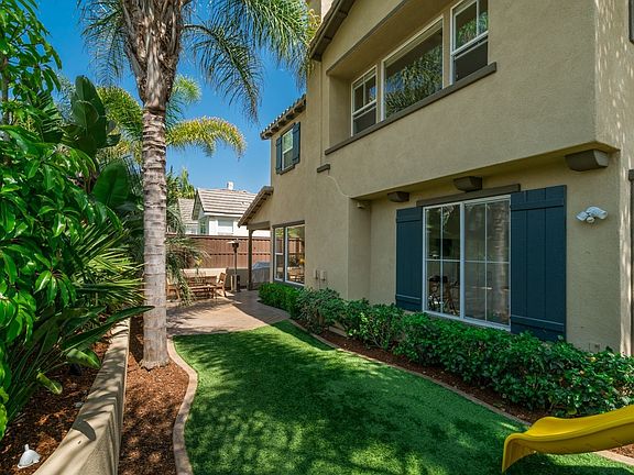 Another view of the spacious true backyard - note the water-smart artificial turf.
