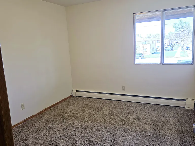 The bedroom is freshly painted and has new carpet.