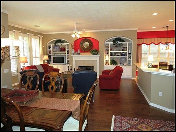 FAMILY ROOM WITH BUILT -IN T.V NICHE AND BOOKSHELVES ON EITHER SIDE OF THE GAS FIREPLACE.
