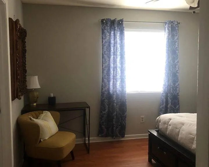 Primary 1st Bedroom with attached en-suite full bathroom with remodeled shower/bath tub combination, dual flush toilet, standard sink vanity with lower cabinet storage and mirrored medicine cabinet.