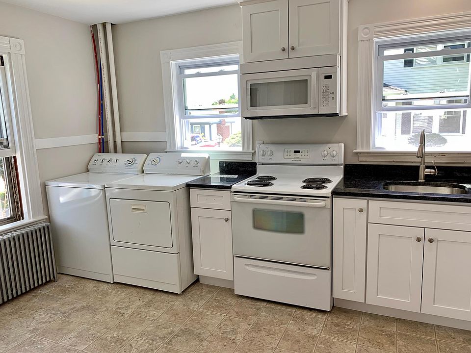 Kitchen with washer, dryer, range, microwave/vent hood, dishwasher and fridge