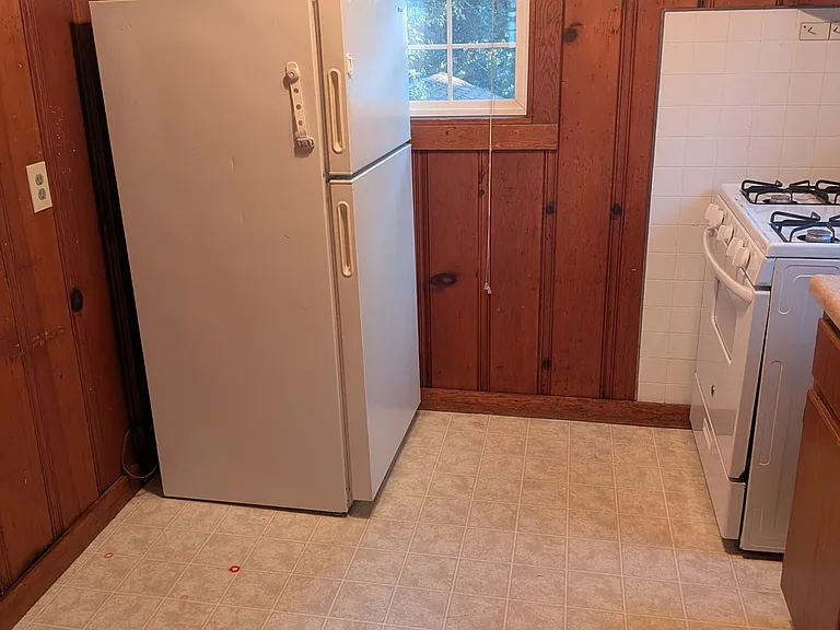 Kitchen features stove and refrigerator