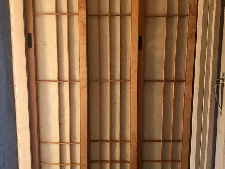 Triple shoji doors enclose laundry