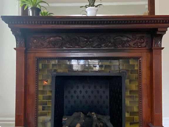 original fireplace and mirror with electric logs