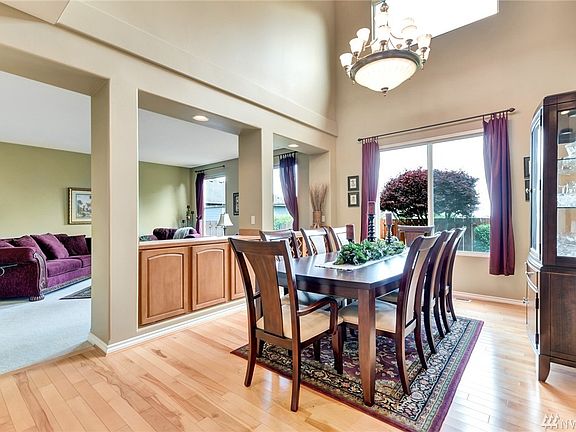 Large dining room with cathedral ceilings overlooking the formal living room