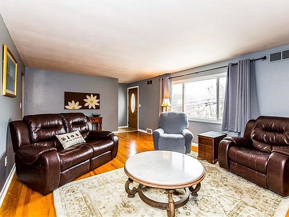 Gleaming hardwood floors throughout this beautiful ranch