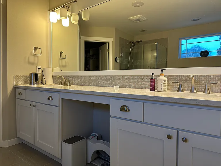 Double vanity bathroom attached to primary room