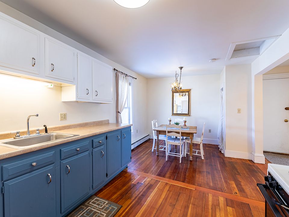 Open concept kitchen and dining with beautiful hardwood floors