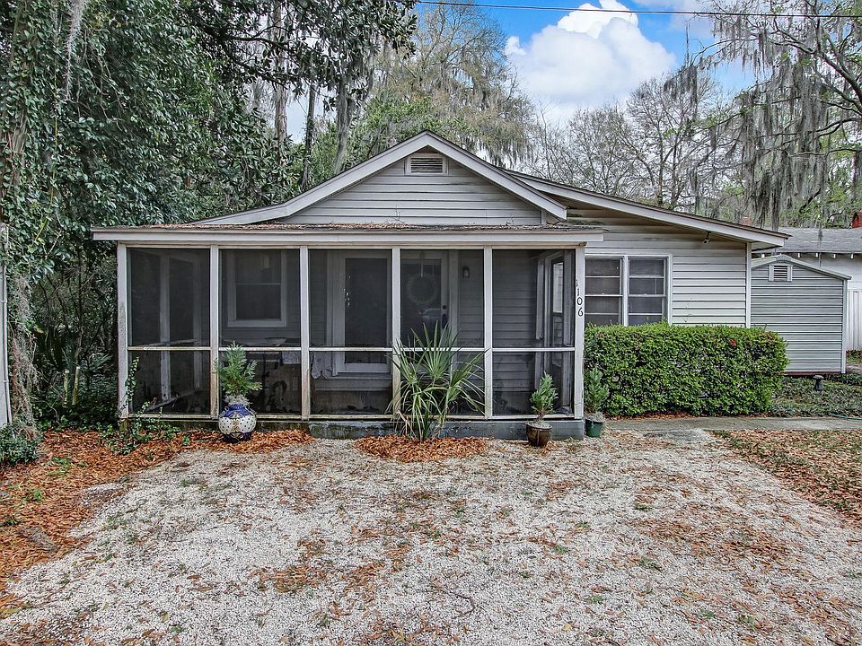Property sits way back on the property with a long driveway and a two-car carport and a beautiful view of the lawn